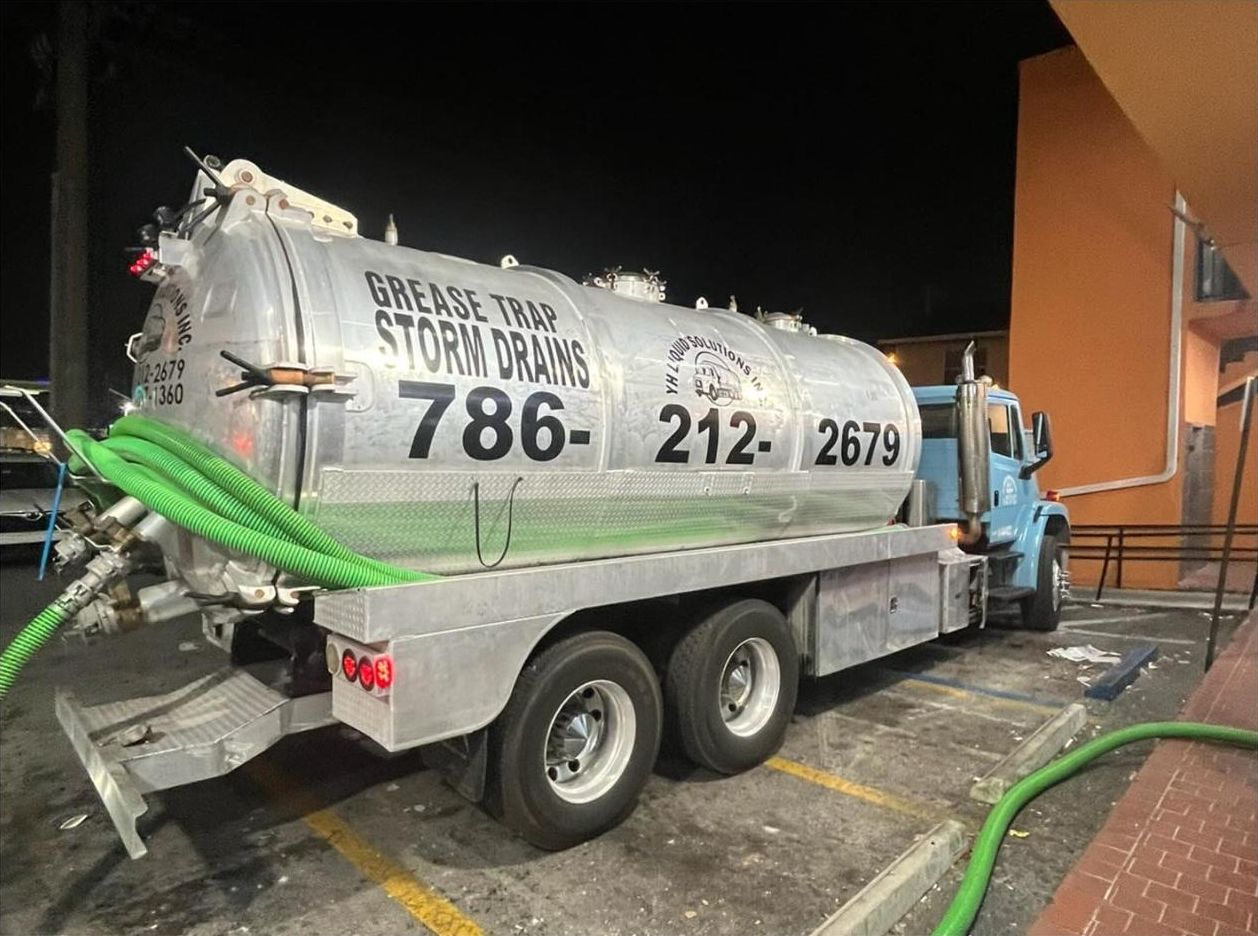 YH Liquid Solutions grease trap and storm drain vacuum truck on a night job at a restaurant
